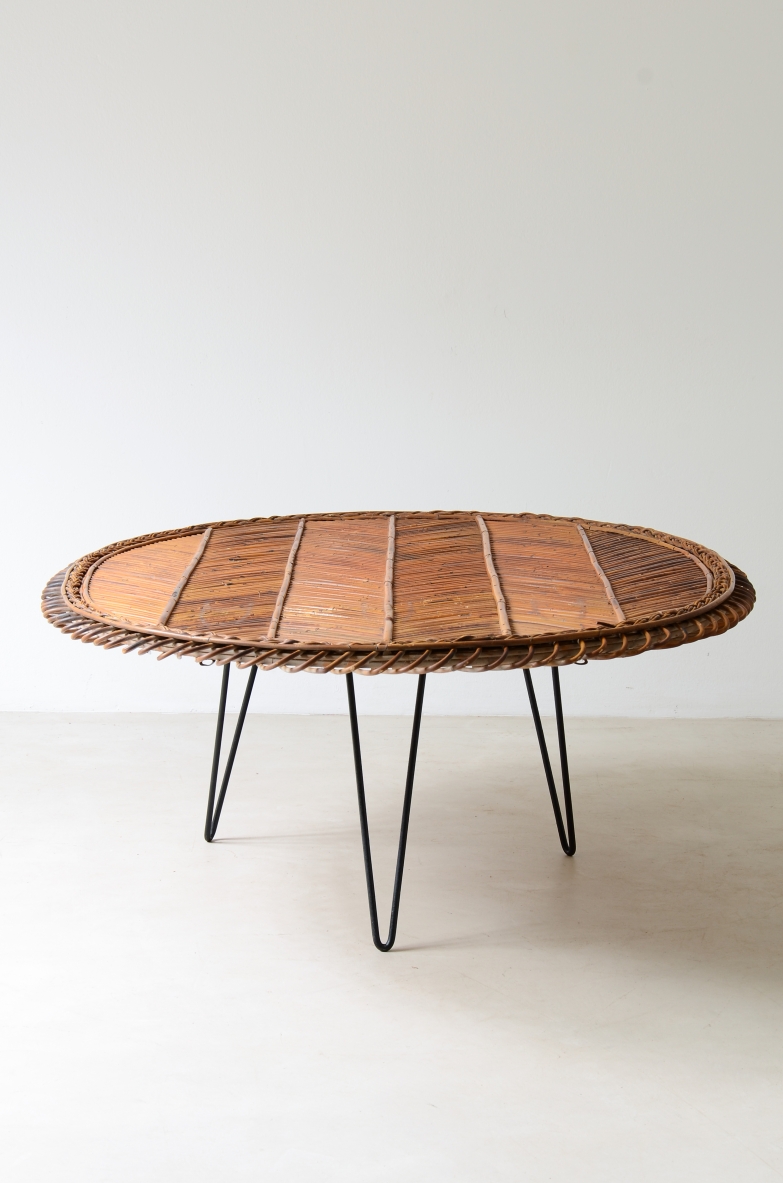 Large low table with herringbone rattan top and curved iron leg. 50's