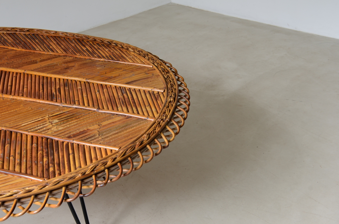 Large low table with herringbone rattan top and curved iron leg. 60's