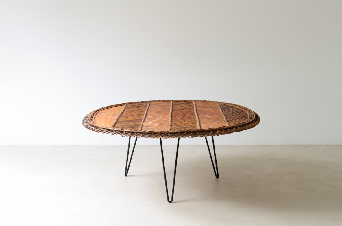 Large low table with herringbone rattan top and curved iron leg. 60's