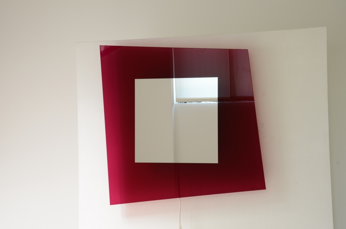 Large backlit mirror in magenta colored tempered glass.  Design Nanda Vigo