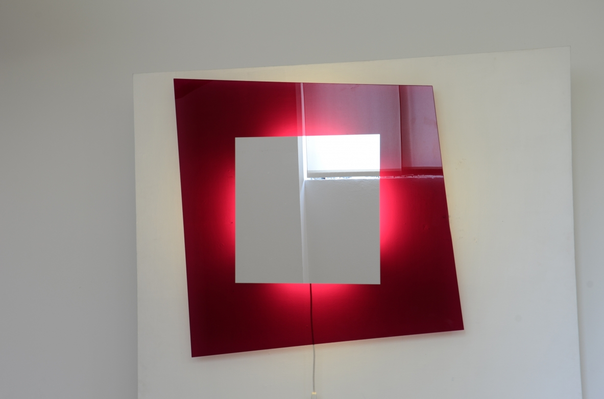 Large backlit mirror in magenta colored tempered glass.  Design Nanda Vigo
