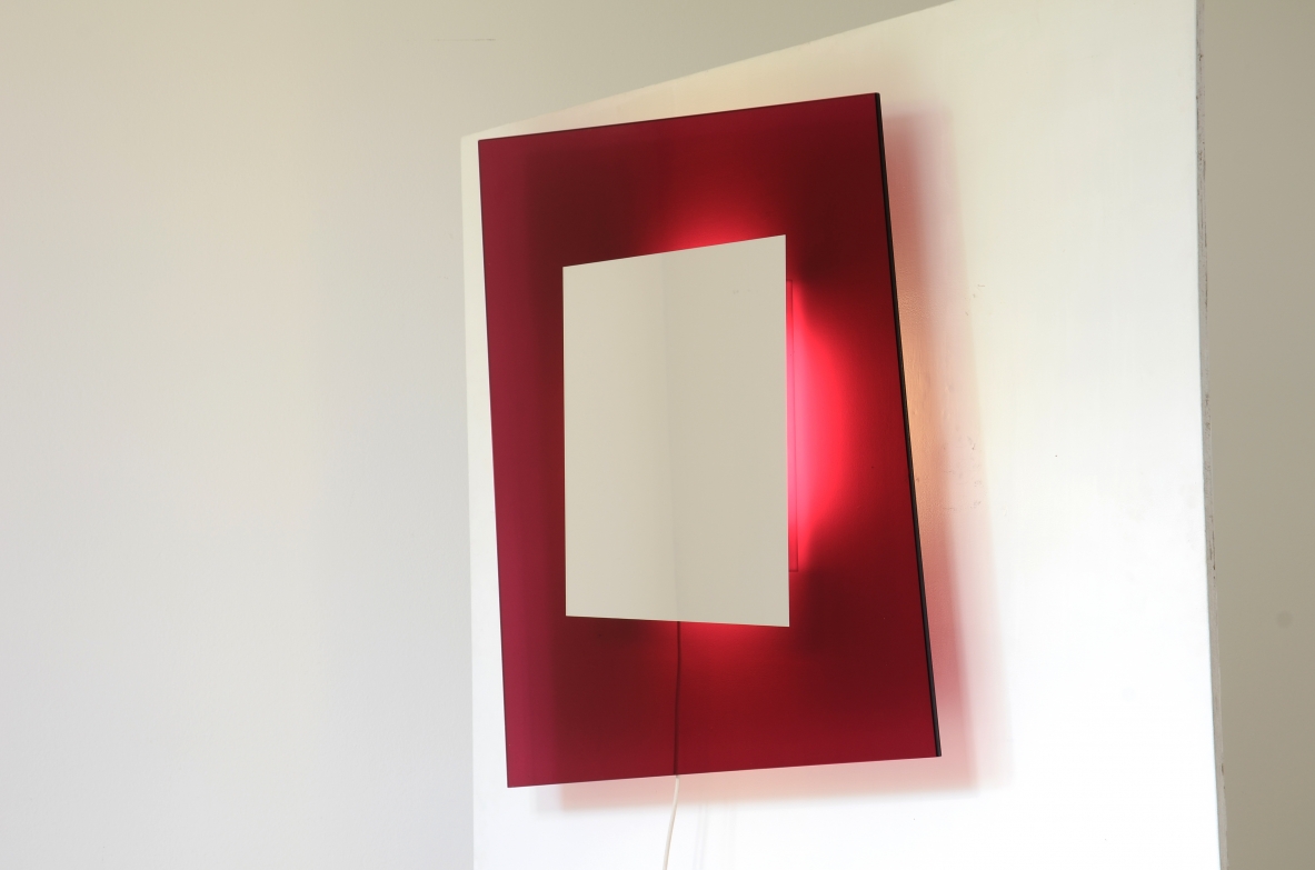 Large backlit mirror in magenta colored tempered glass.  Design Nanda Vigo