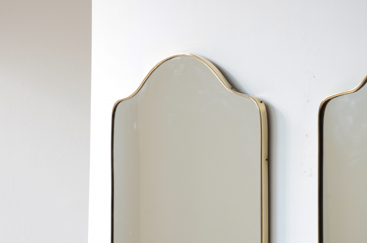 Pair of mirrors with shaped brass frame.  Italian manufacture, 1950s.