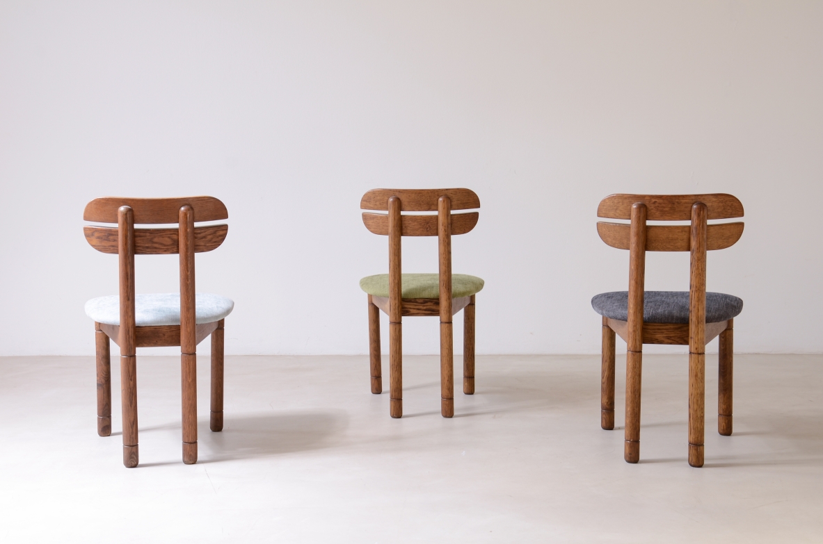 Set of 10 1960s oak chairs with shaped backrest and padded fabric seat.