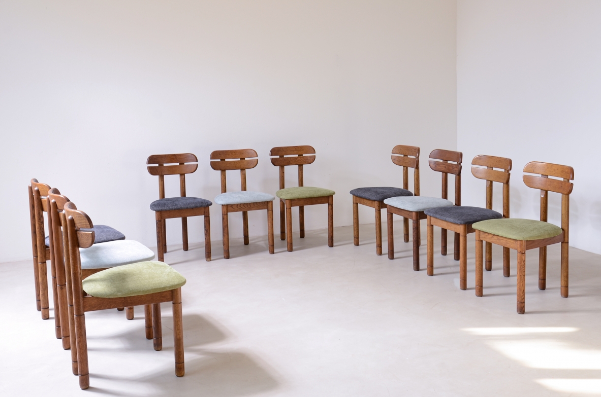 Set of 10 1960s oak chairs with shaped backrest and padded fabric seat.