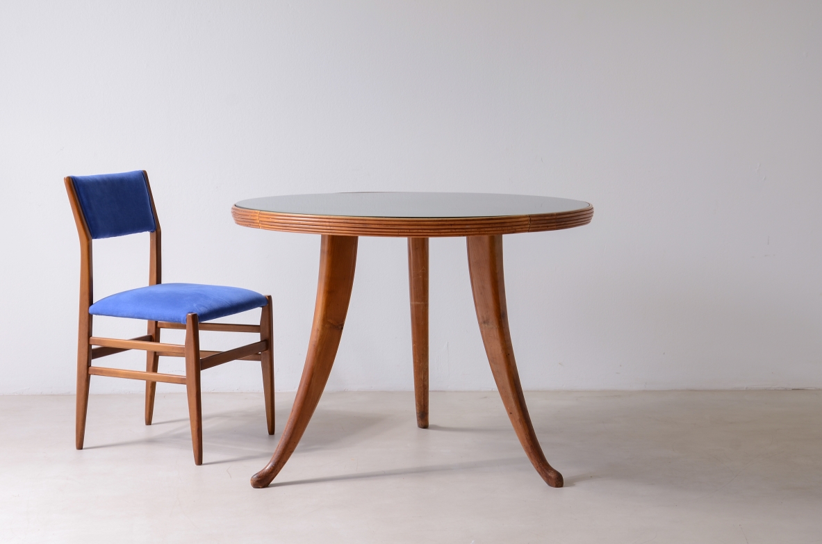 Elegant walnut table with sabre legs, striped band and cut glass top.  Italian manufacture from the 1940s.