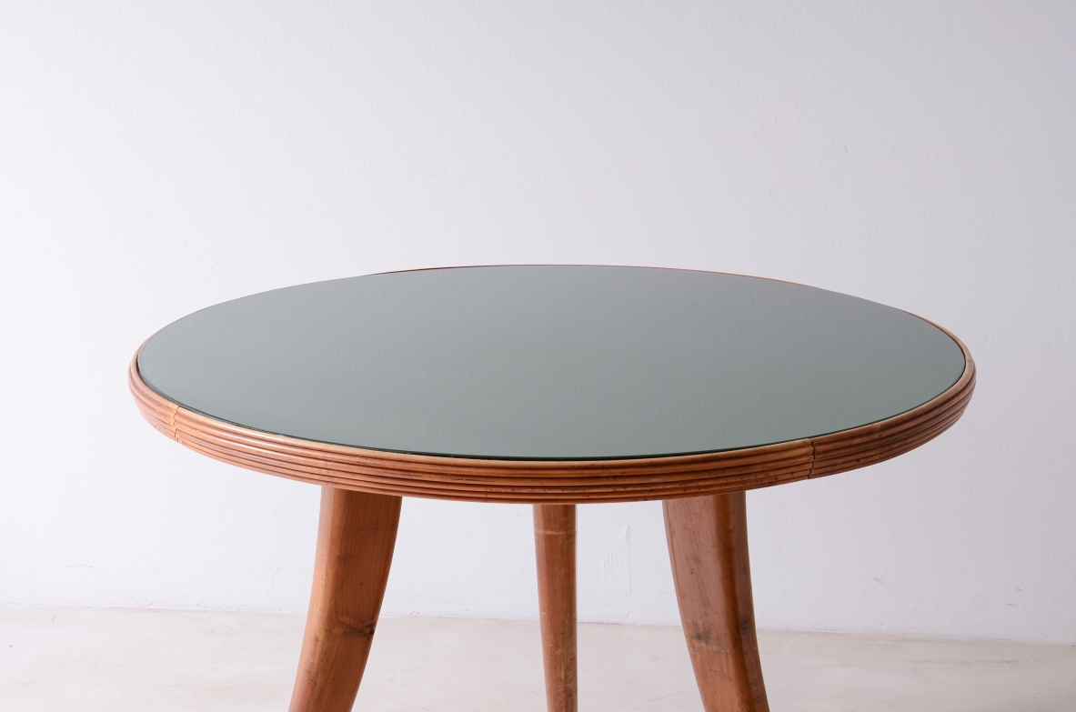 Elegant walnut table with sabre legs, striped band and cut glass top.  Italian manufacture from the 1940s.
