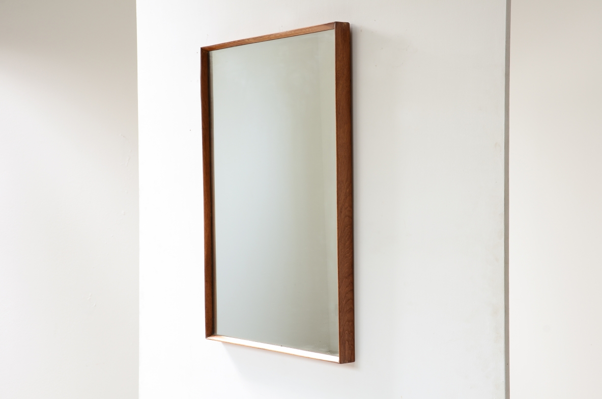 Two mirrors with shaped wooden frames.