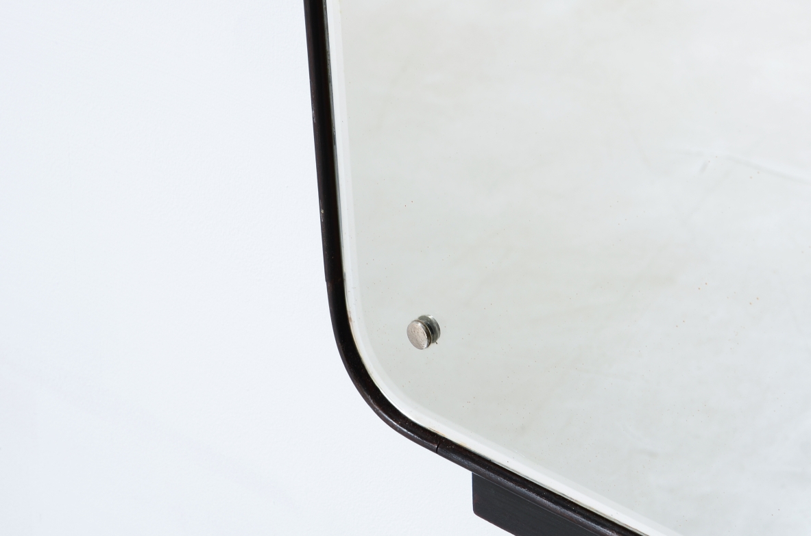 Large mirror with a shaped wooden frame. Italian manufacture, circa 1950.