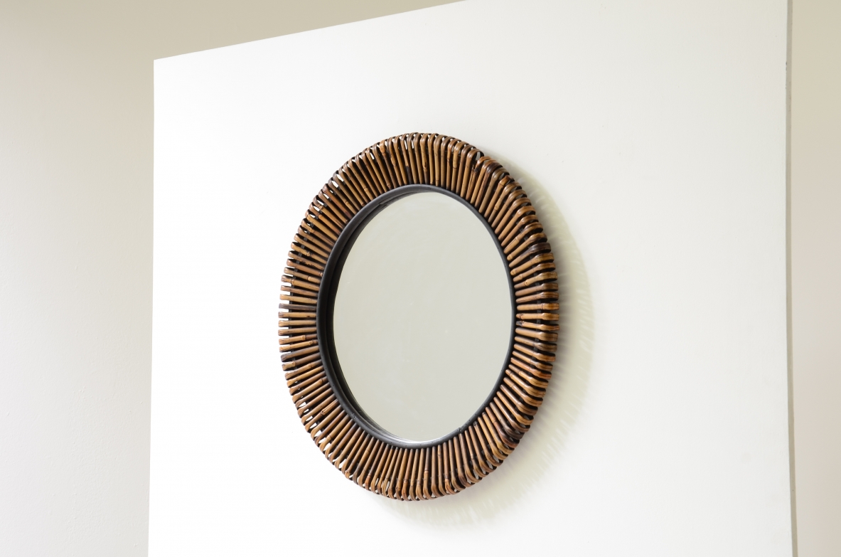 Beautiful mirror with a sunburst cane frame.  Italian manufacture, circa 1950-60.