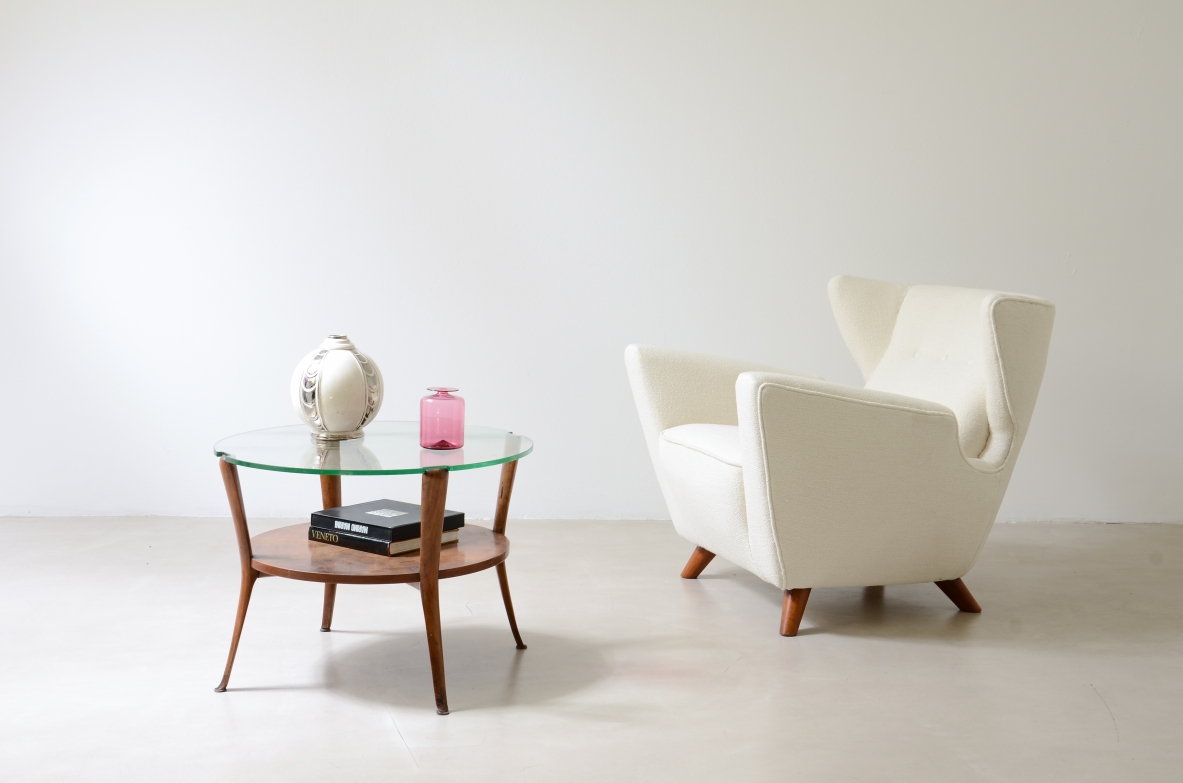 Walnut coffee table with a thick beveled glass top and four elegantly shaped legs.Italian manufacture, ca. 1950.