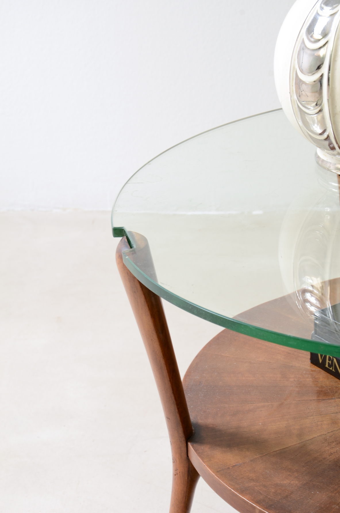 Walnut coffee table with a thick beveled glass top and four elegantly shaped legs.Italian manufacture, ca. 1950.