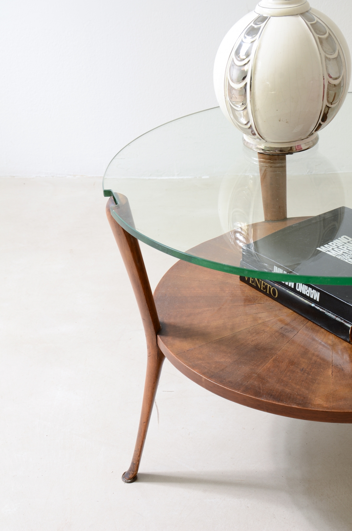 Walnut coffee table with a thick beveled glass top and four elegantly shaped legs.Italian manufacture, ca. 1950.
