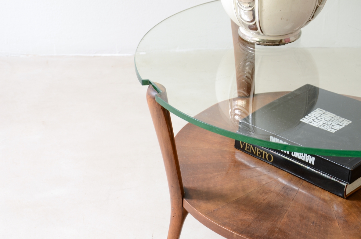 Walnut coffee table with a thick beveled glass top and four elegantly shaped legs.Italian manufacture, ca. 1950.