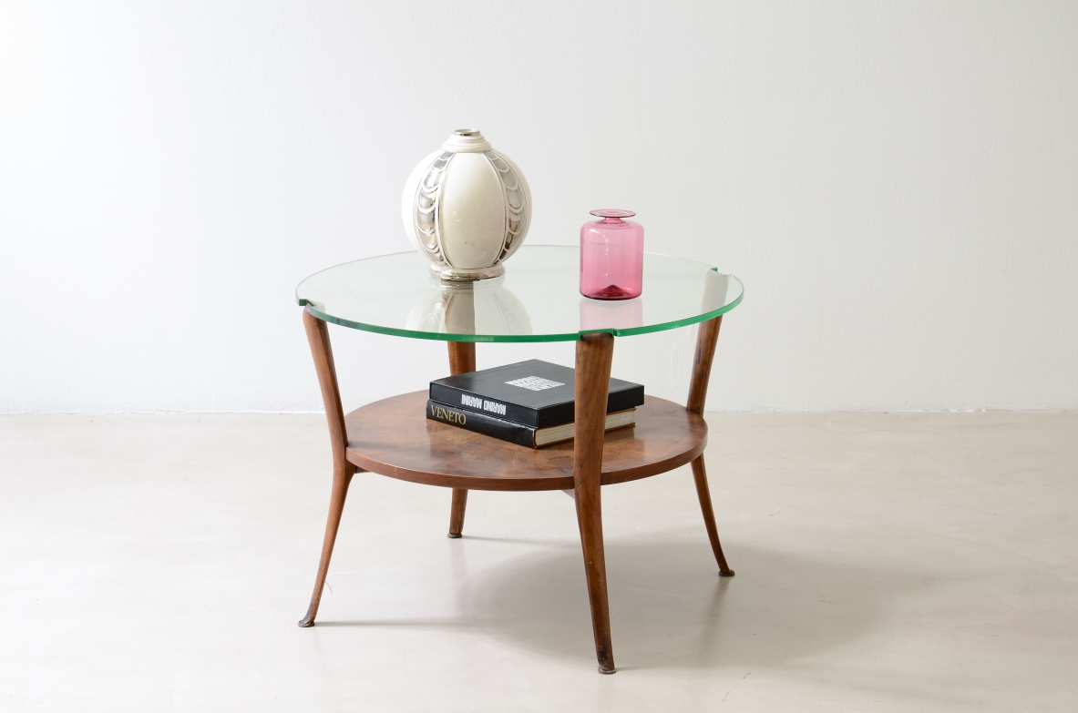 Walnut coffee table with a thick beveled glass top and four elegantly shaped legs.Italian manufacture, ca. 1950.