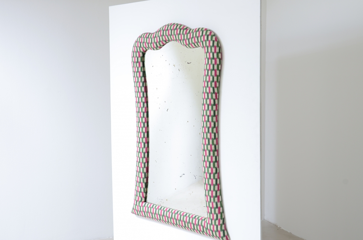 Large mirror with a shaped frame and fabric covering.Italian manufacture,ca. 1880-1900.