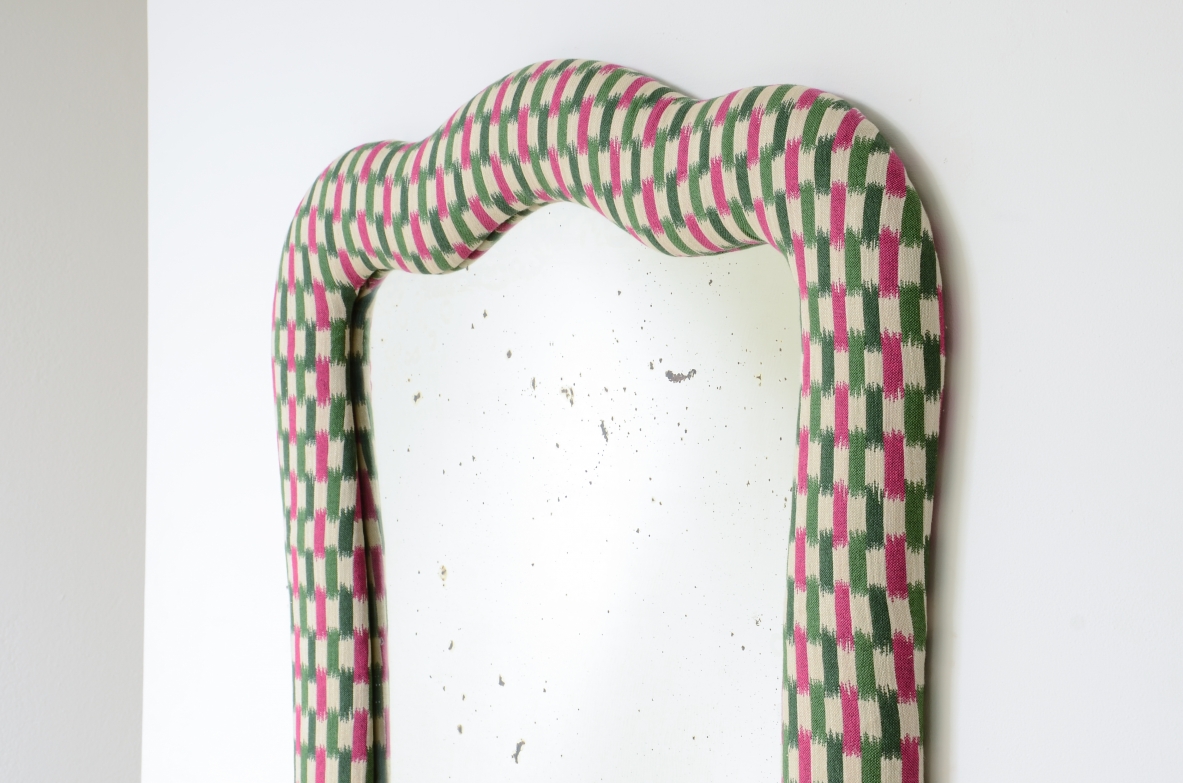 Large mirror with a shaped frame and fabric covering.Italian manufacture,ca. 1880-1900.
