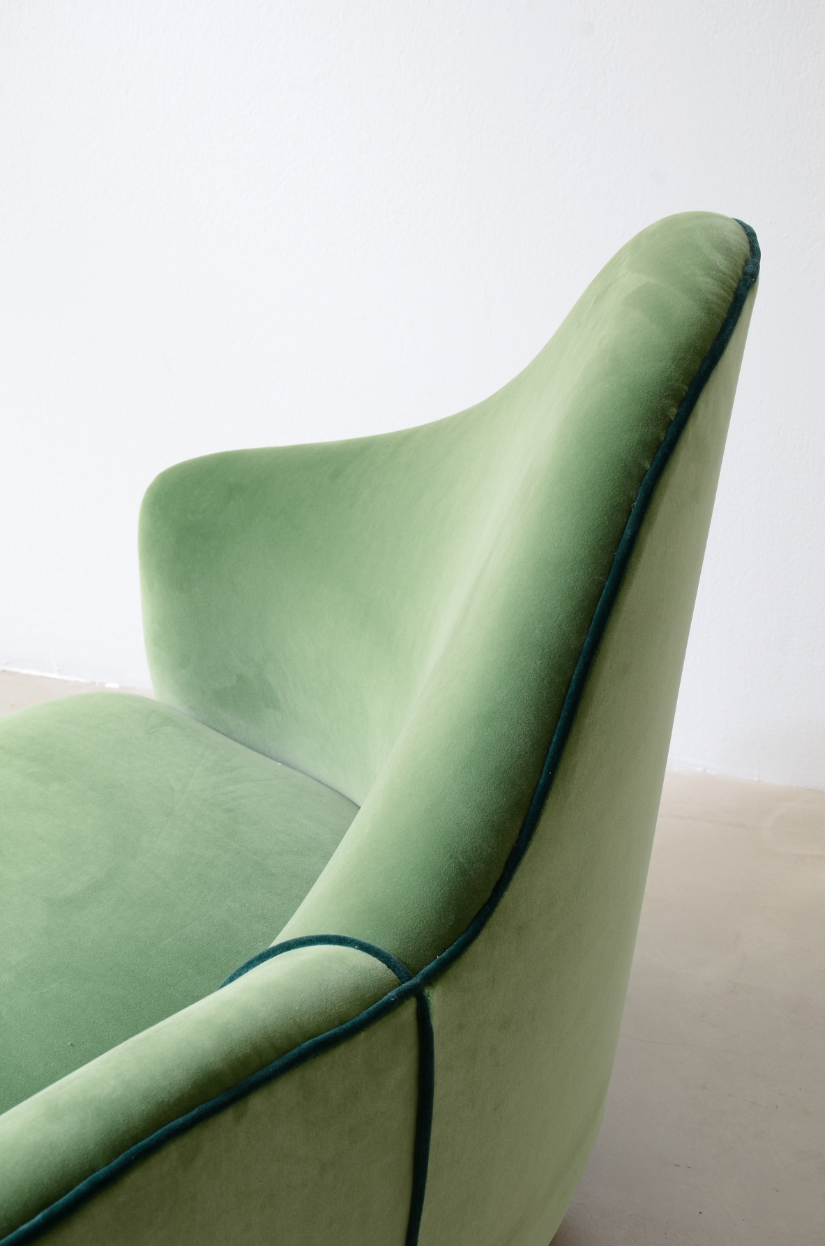 Cesare Lacca  A rare two-seater sofa with enveloping lines, Turned wooden legs.  Italian manufacture, 1950s