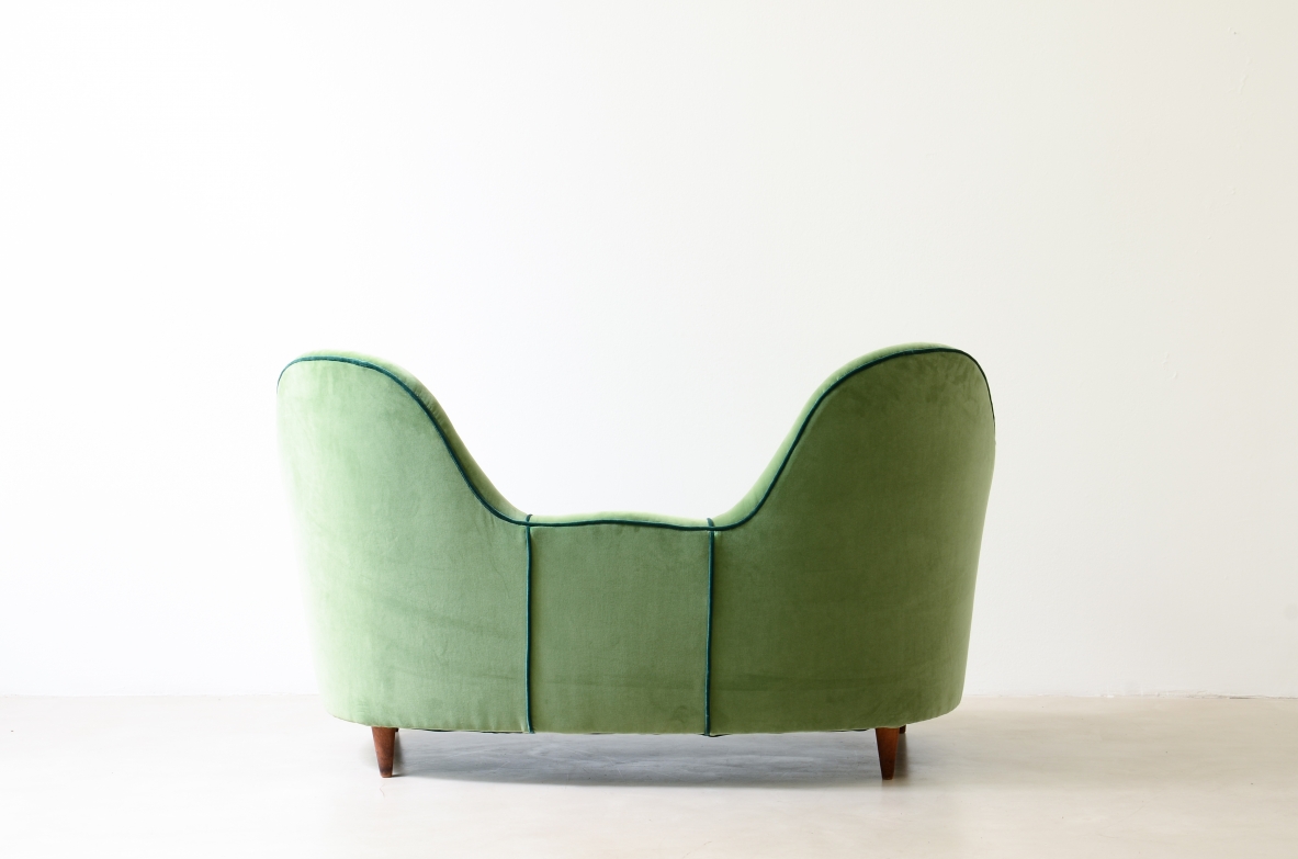 Cesare Lacca  A rare two-seater sofa with enveloping lines, Turned wooden legs.  Italian manufacture, 1950s