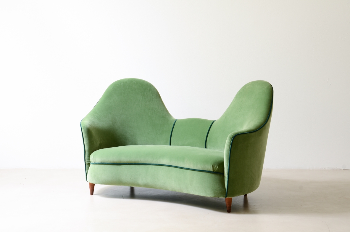Cesare Lacca  A rare two-seater sofa with enveloping lines, Turned wooden legs.  Italian manufacture, 1950s