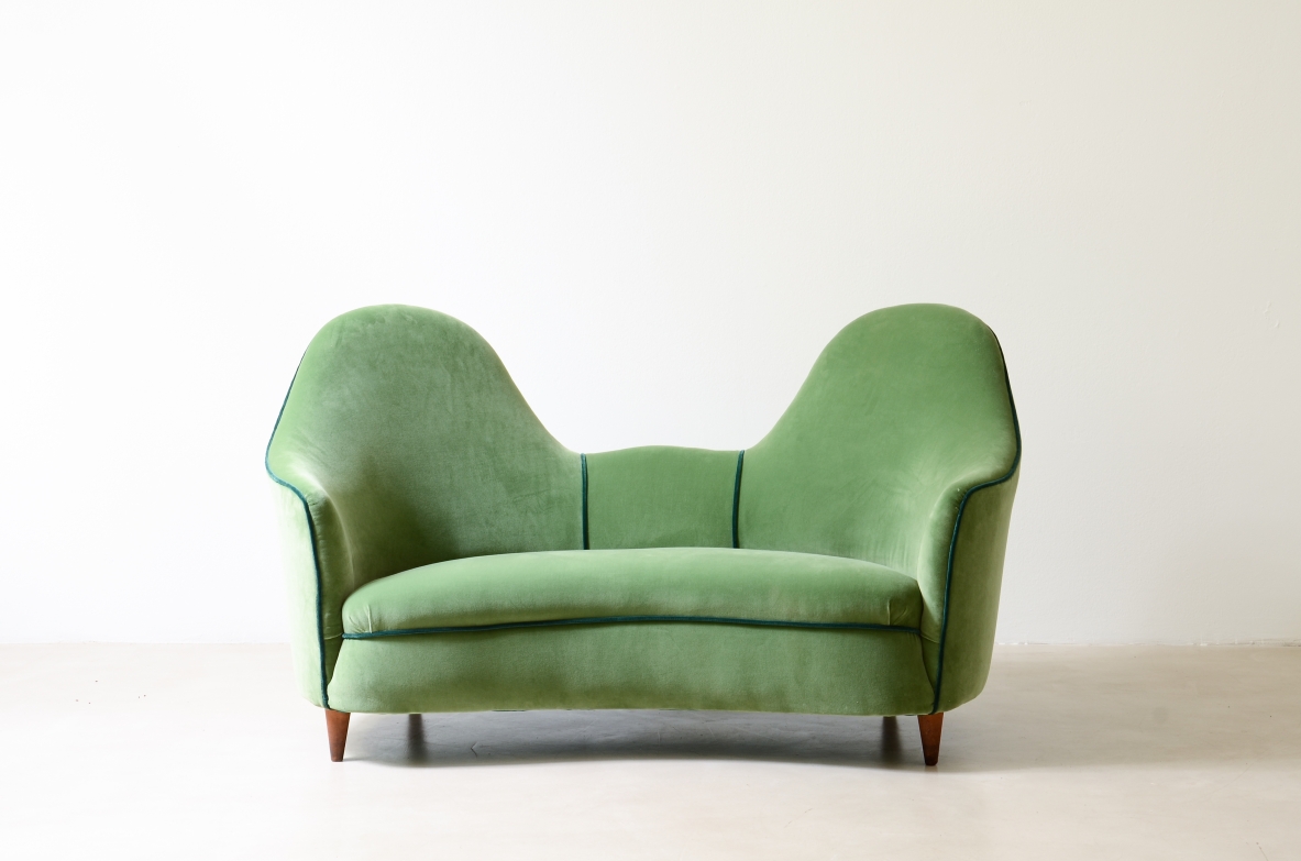 Cesare Lacca  A rare two-seater sofa with enveloping lines, Turned wooden legs.  Italian manufacture, 1950s