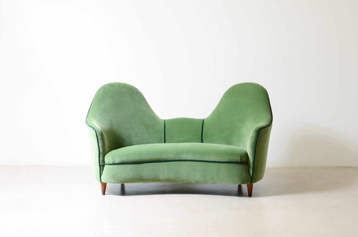 Cesare Lacca  A rare two-seater sofa with enveloping lines, Turned wooden legs.  Italian manufacture, 1950s