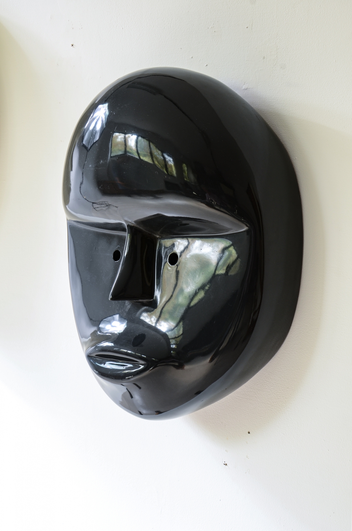 Pair of large lacquered fiberglass masks, Attributed to Joe Colombo; manufactured circa 1970.