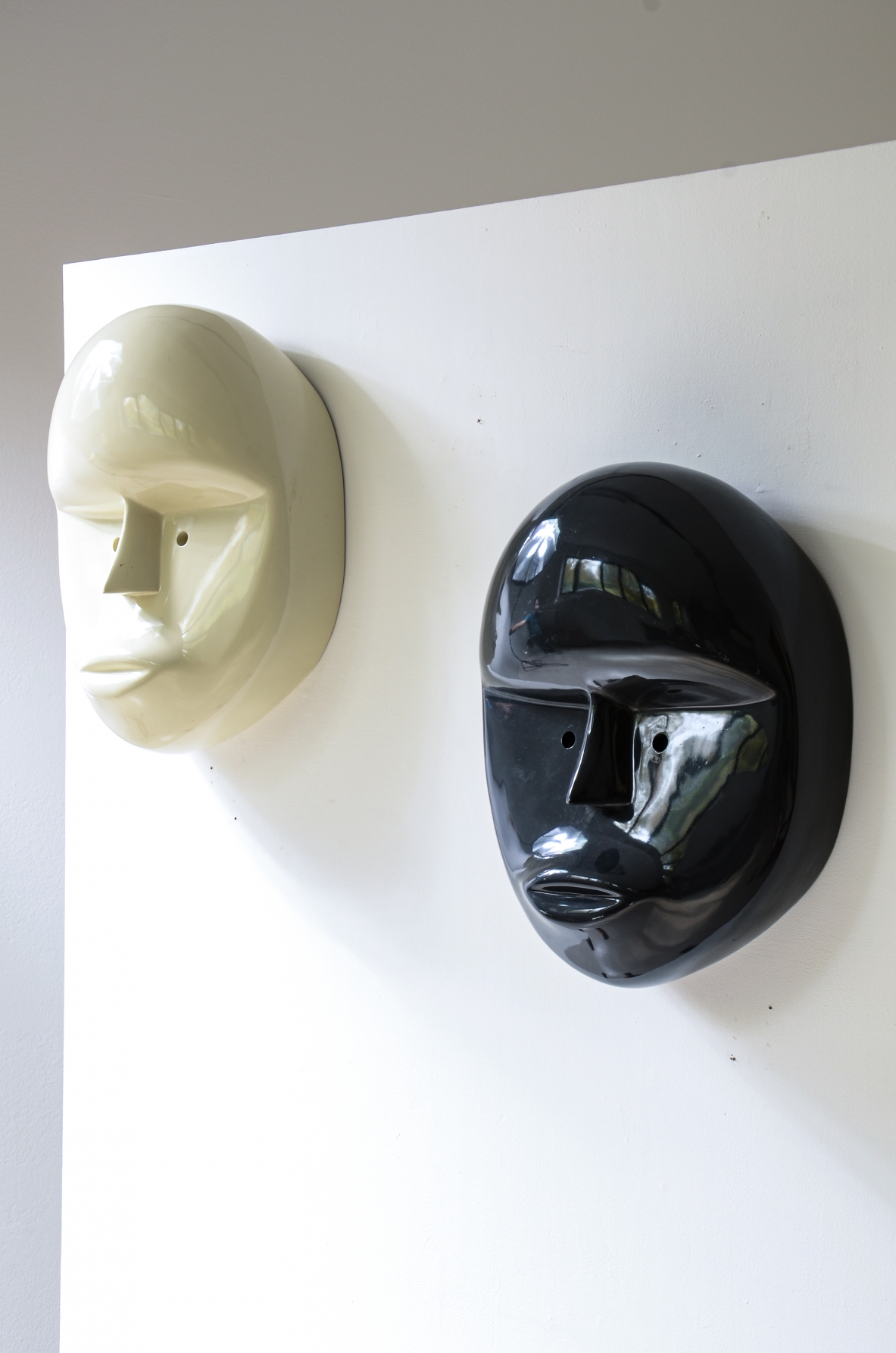 Pair of large lacquered fiberglass masks, Attributed to Joe Colombo; manufactured circa 1970.