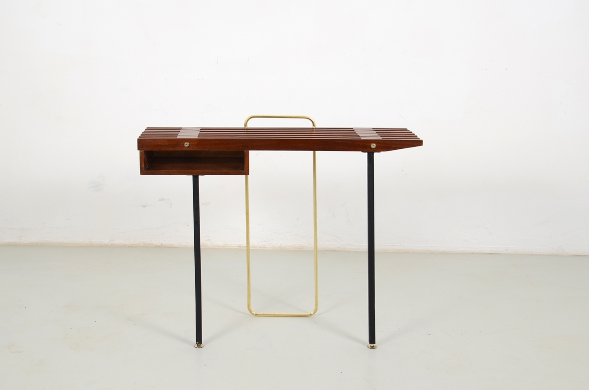 1950's Italian console table in teak wood, metal legs on front and brass O on the back.
