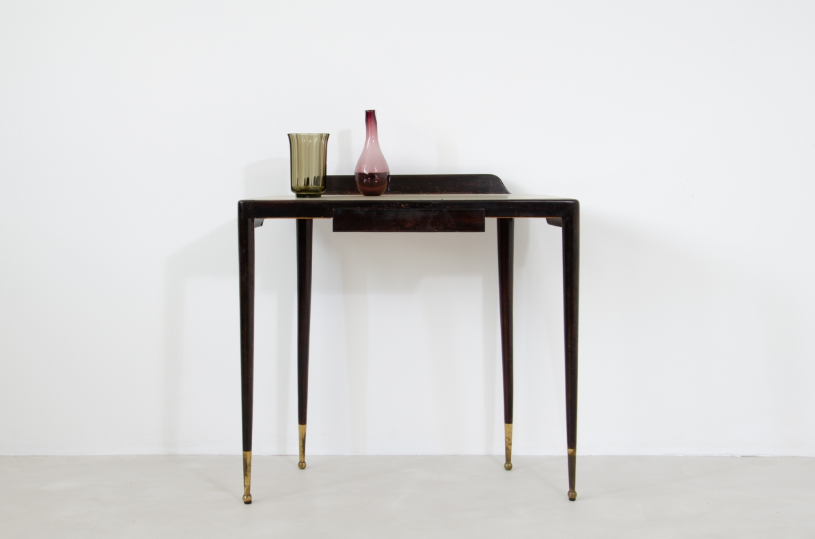 Elegant Console table with thin legs in stained wood and long brass tips. Central drawer and top in ivory opaline glass.  1950's Italian manufacture.