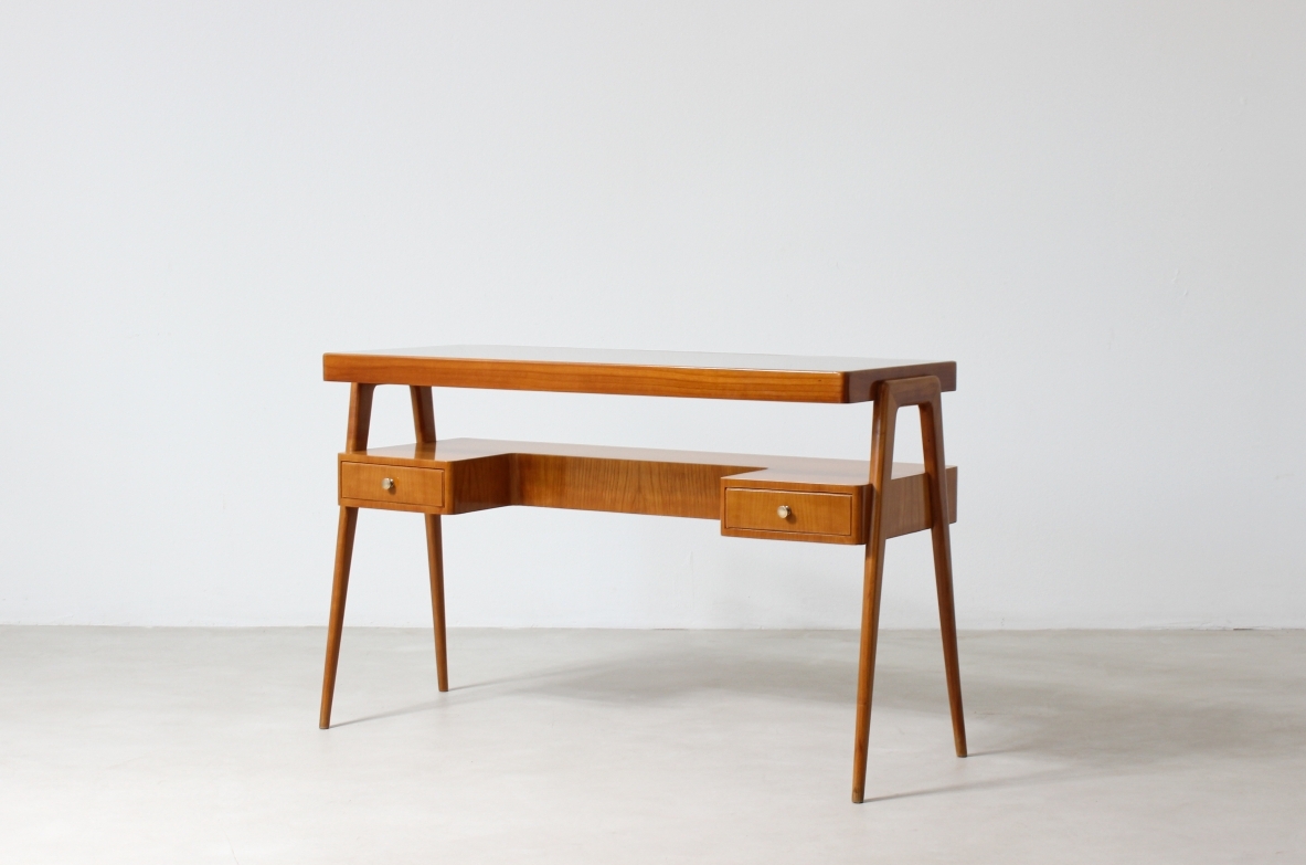 Consolle desk in blond wood with glass top and shaped shelf with two drawers on the front.  Italian manufacture, 1950's.