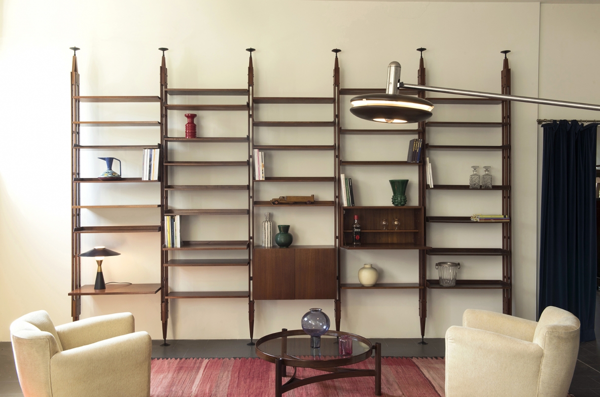 Franco Albini, Infinito bookcase.Large modular bookcase made up of 6 vertical uprights, container elements with hinged doors and lower doors with 22 tek wood shelves.