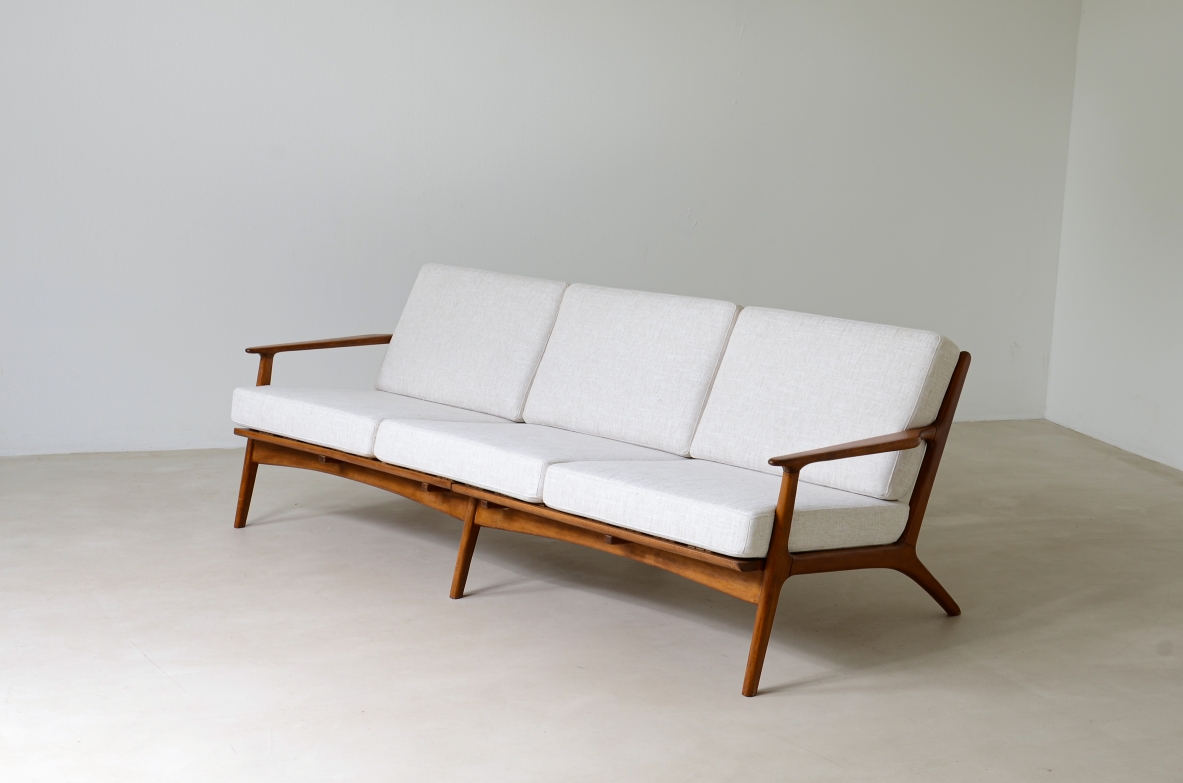 Ib Kofod Larsen  Sofa in teak with seat and back in upholstered fabric.