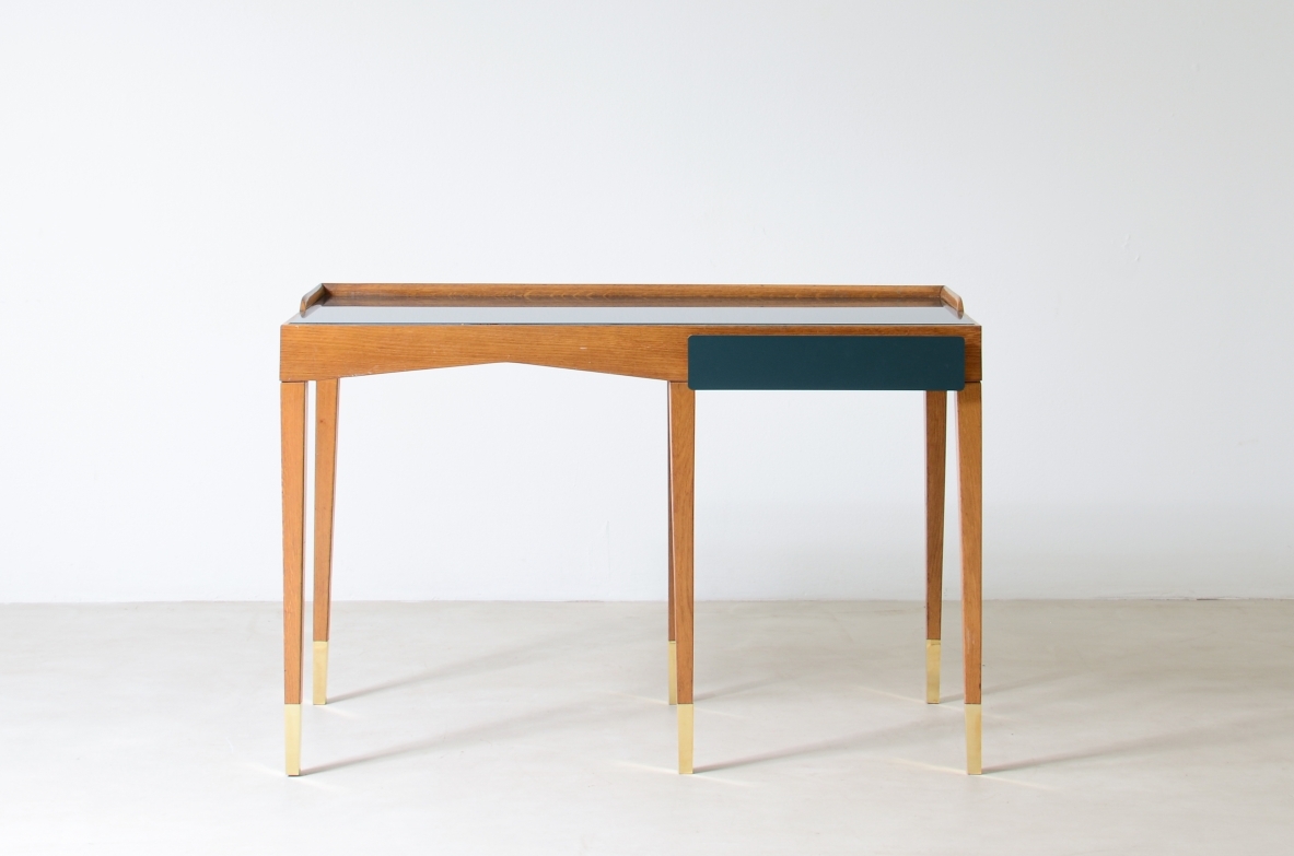 Refined oak writing desk with petrol green opaline glass top and backsplash.  Shaped drawer of the same color covered in polypropylene. Long thin legs with brass tips.  Attributed to Gio Ponti, early 1950s manufacture.
