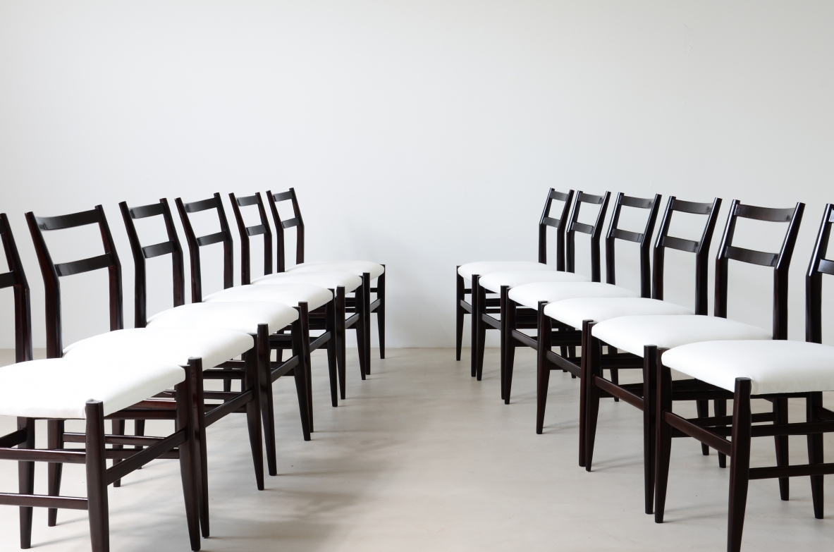 Gio Ponti (1891-1976)  Set of 12 chairs in black stained wood with fabric covering.  Modello leggera,  Cassina manufacture 1954.