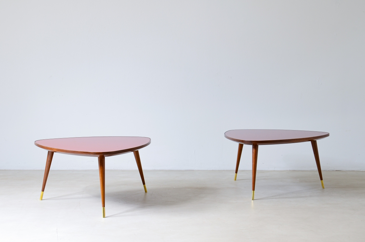 Osvaldo Borsani  Pair of coffee tables with cut glass top and truncated conical legs with brass tip.