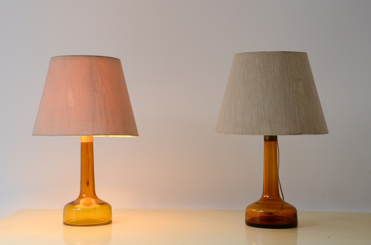 Pair of colored glass lamps with brass detail and fabric shade with perplexed disc.