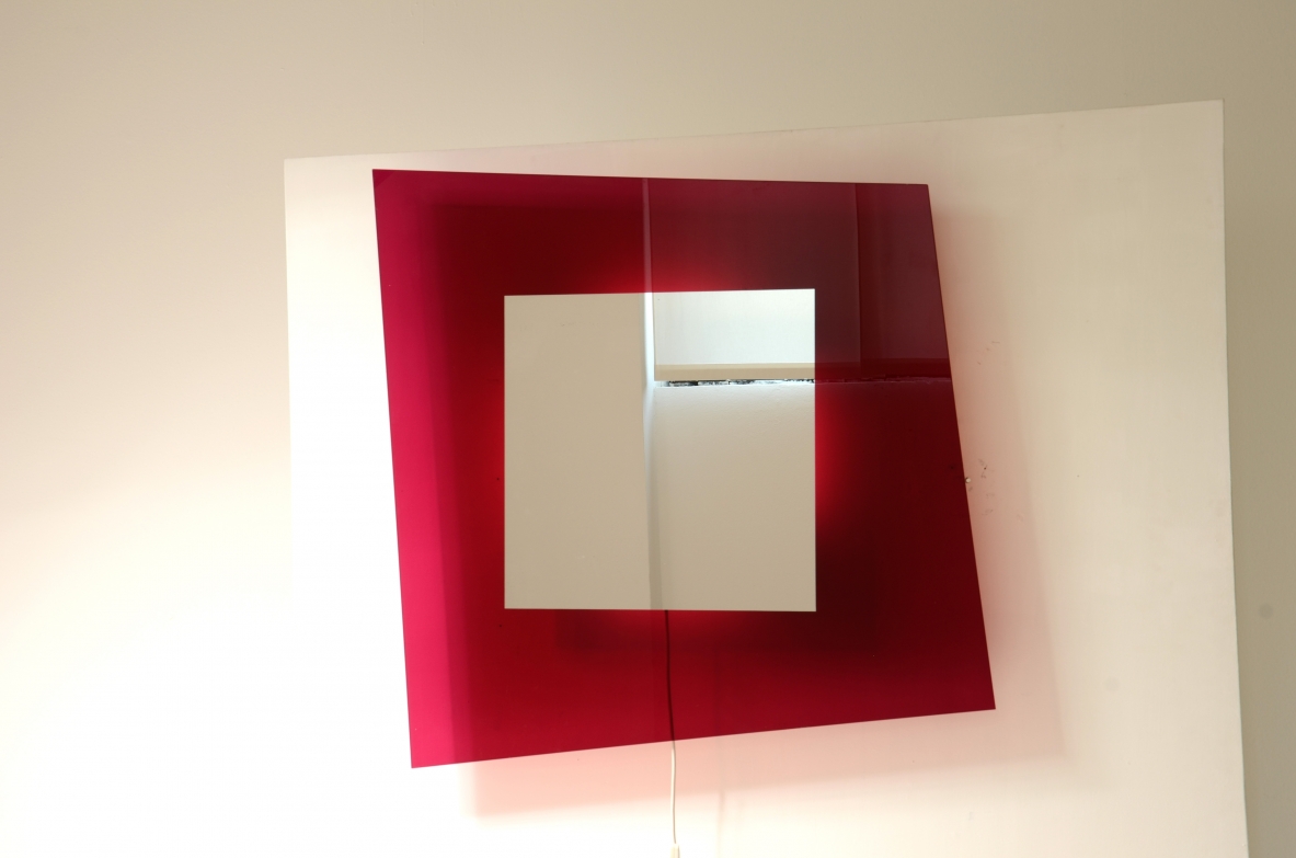 Large backlit mirror in magenta colored tempered glass.  Design Nanda Vigo