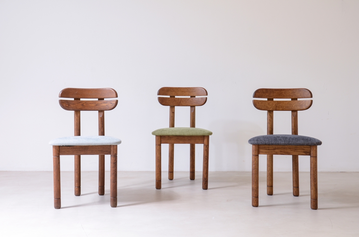 Set of 10 1960s oak chairs with shaped backrest and padded fabric seat.