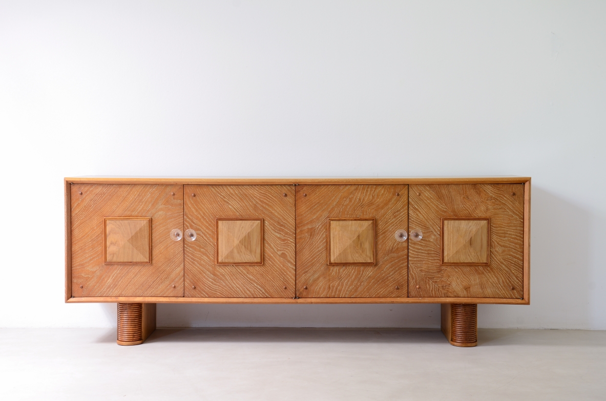 Large 4-door oak cabinet with central diamond decorative motif and curved wood bases, 1940.