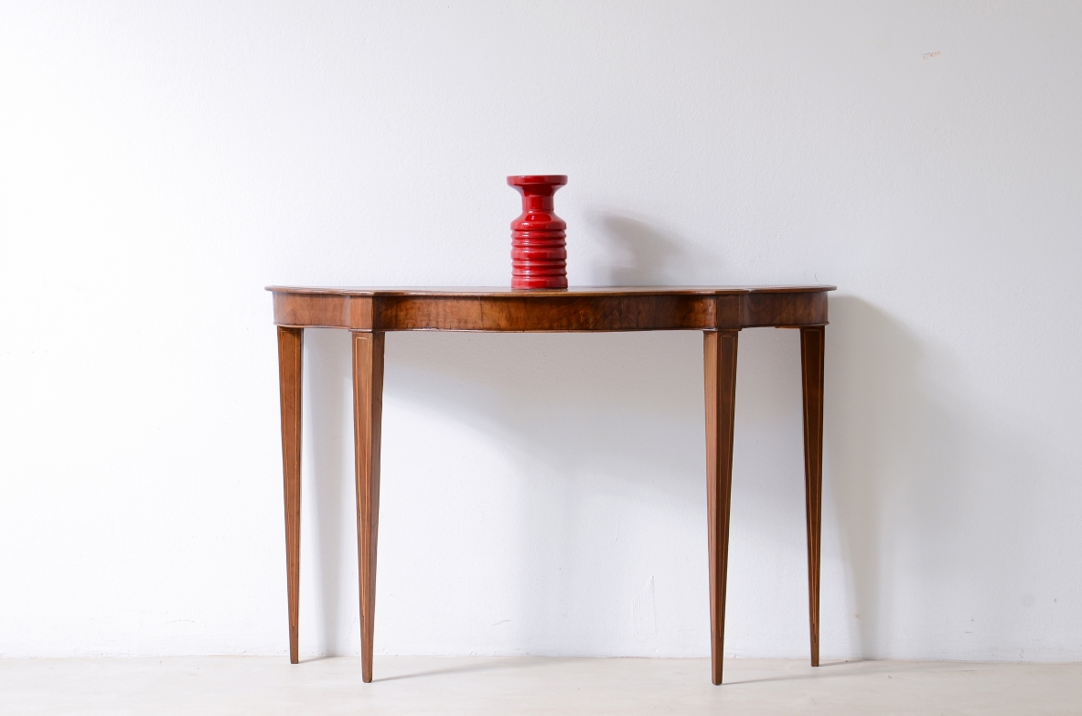 Small console in walnut with shaped top and thin tapered legs.1780ca
